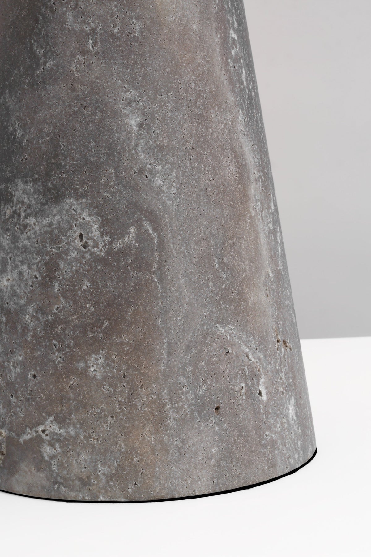 Detail of the Aegis Medium travertine base and brass shade