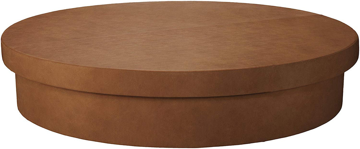 Studio view of a La Fête round Sun Pad daybed in Cognac vinyl