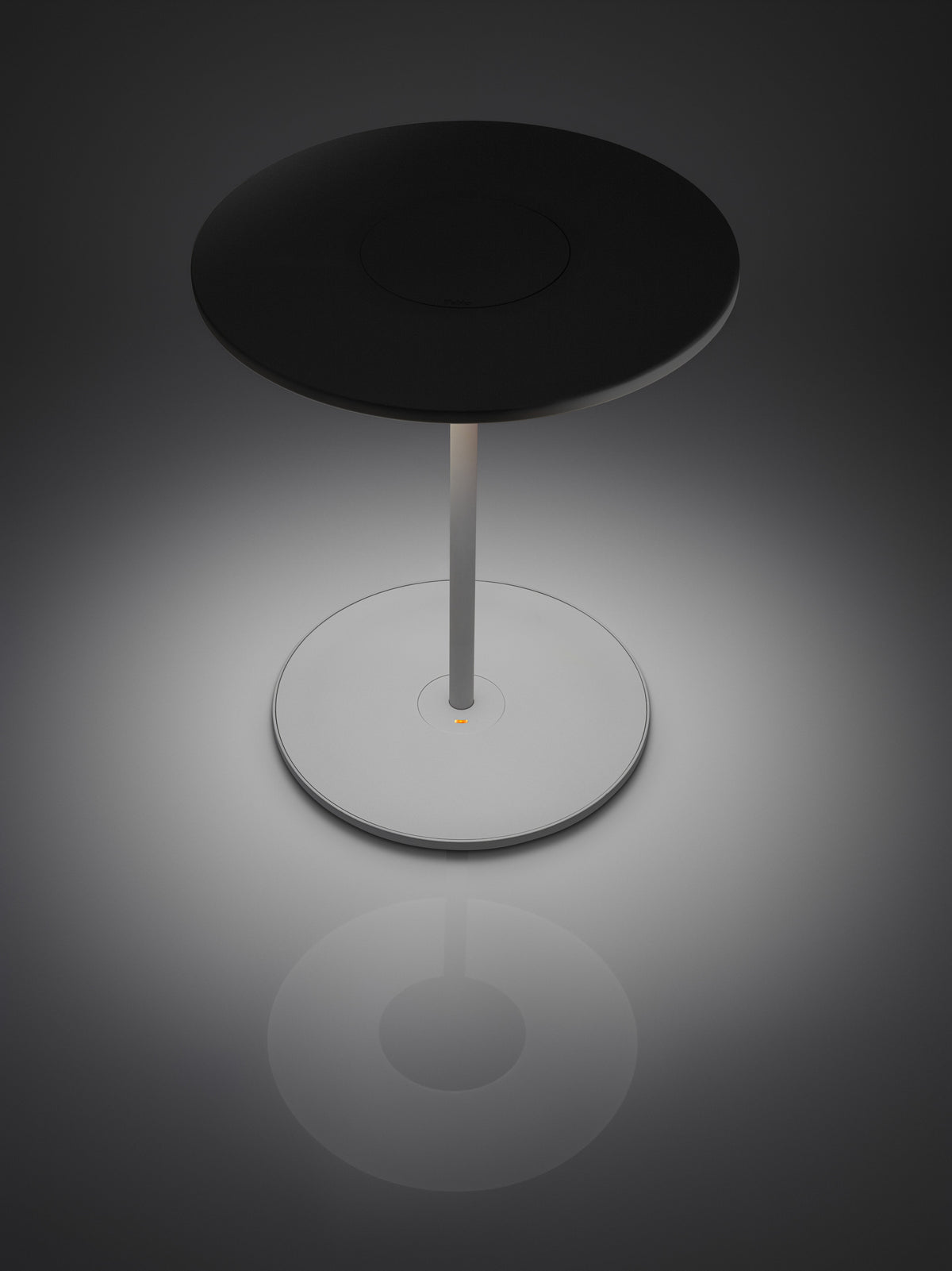 Circa white disc lamp tilted forward, lifestyle close-up