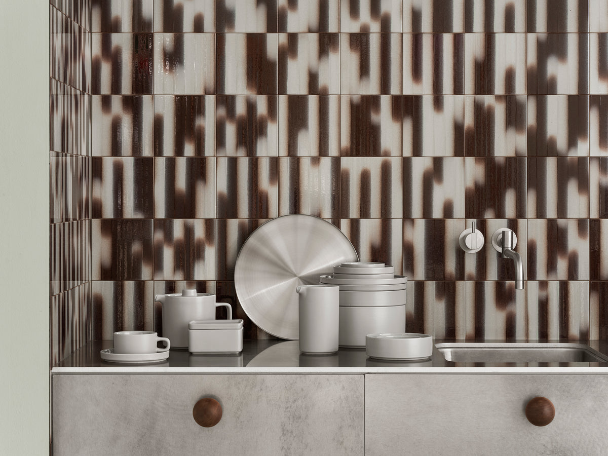 blomus PILAR Stoneware Deep Plates 8 in, Set of 4 – Mirage Grey PILAR pieces stacked on a tiled sideboard