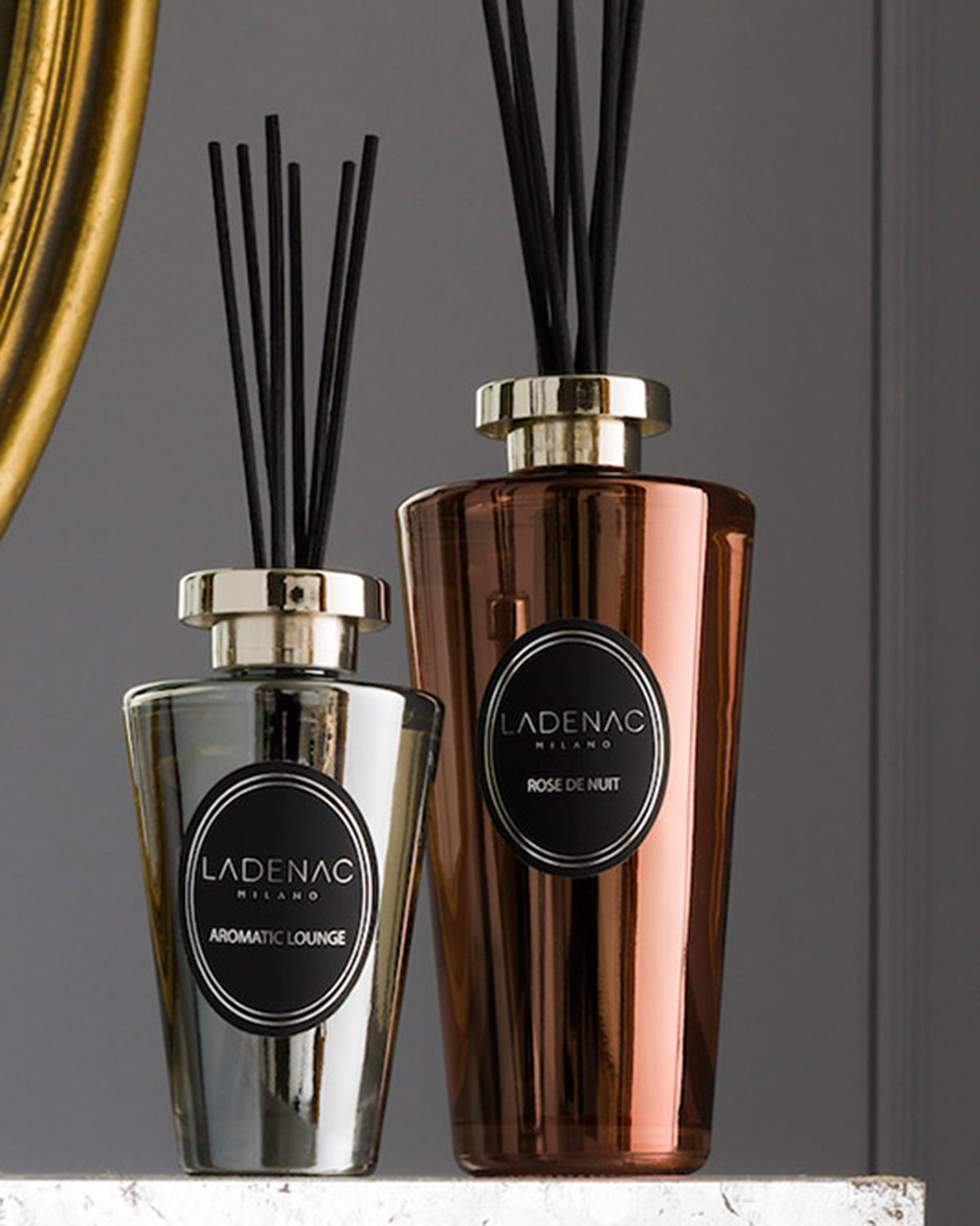 Urban Senses deluxe reed diffuser 500 ml by Ladenac Milano, silver and gold pink diffusers on a dark backdrop