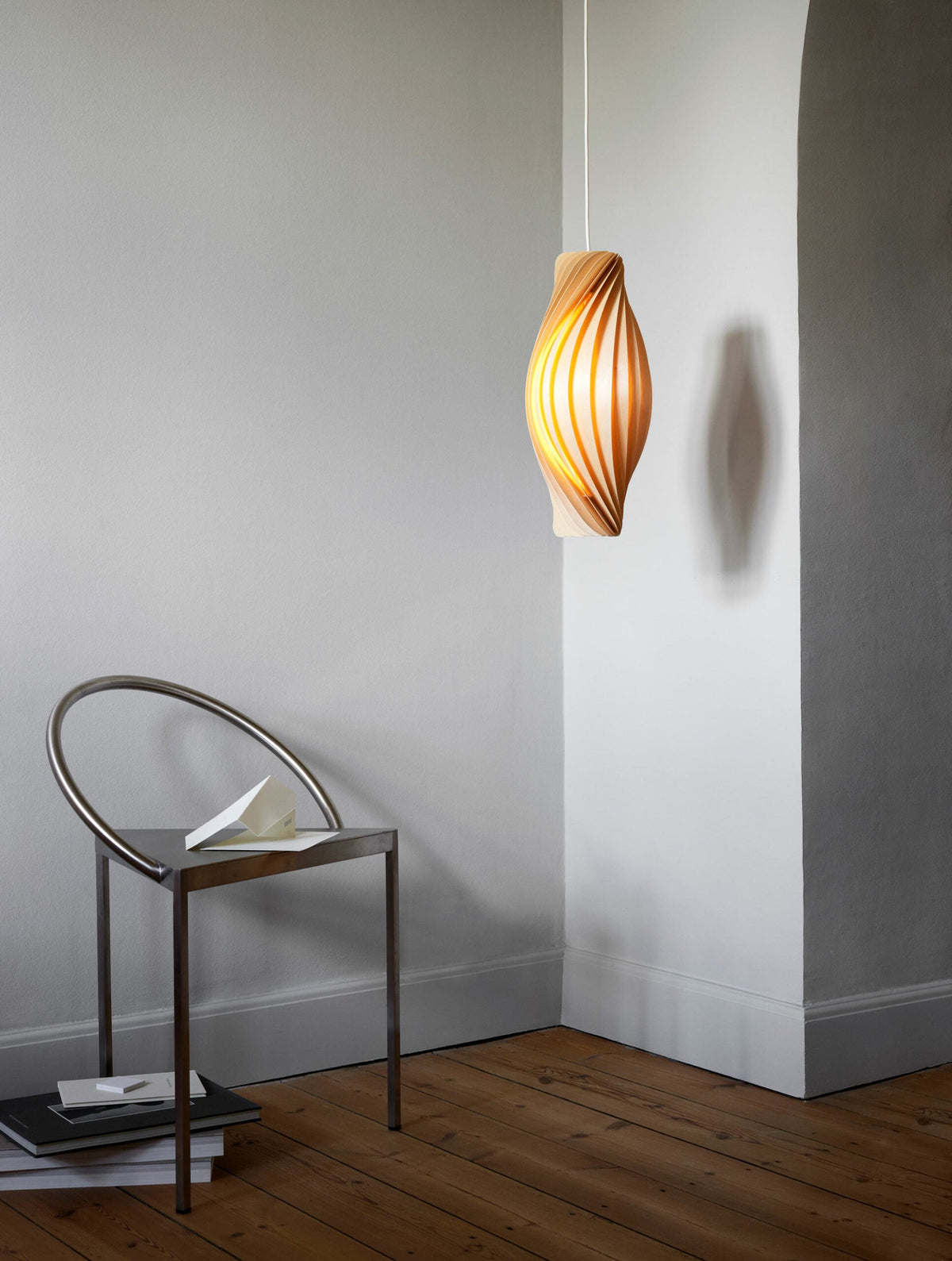 Tom Rossau No.111 pendant light – near a white wall, lit