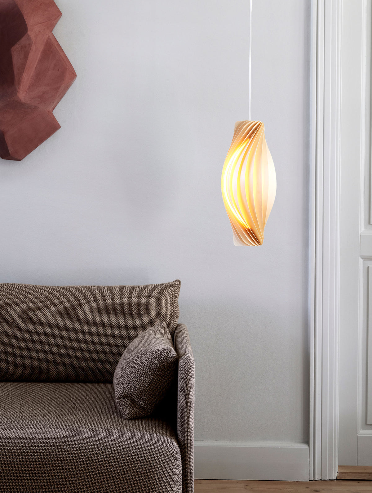 Tom Rossau No.111 pendant light – lit beside a wall