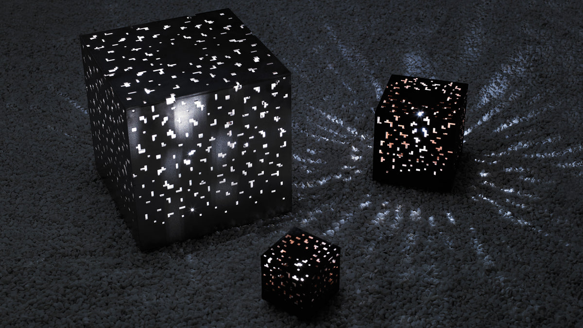 Black perforated AMS cube lamps glowing at night
