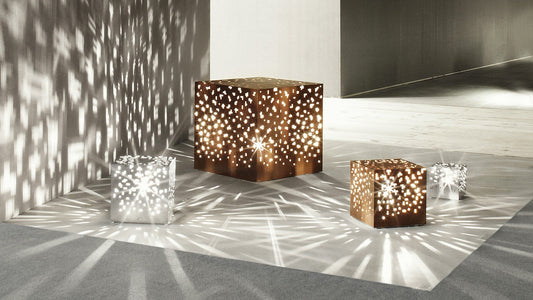 AMS cube lamps in corten and stainless steel casting patterned light on a floor