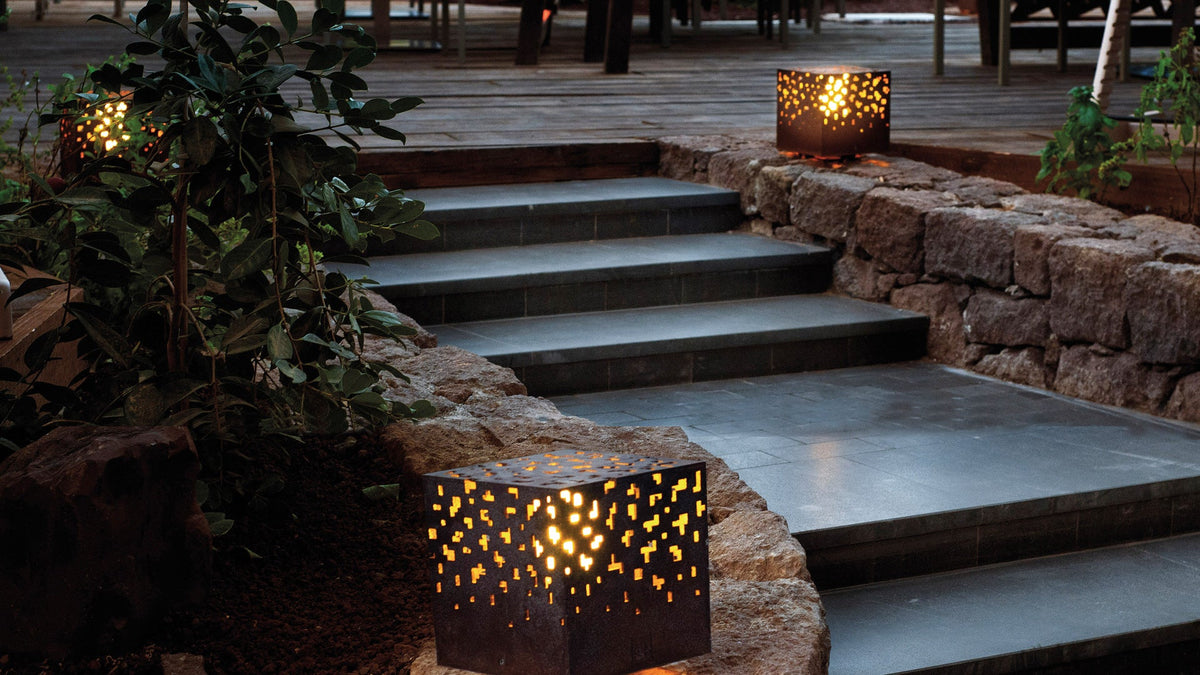Corten steel AMS cube lamps lighting garden steps at dusk