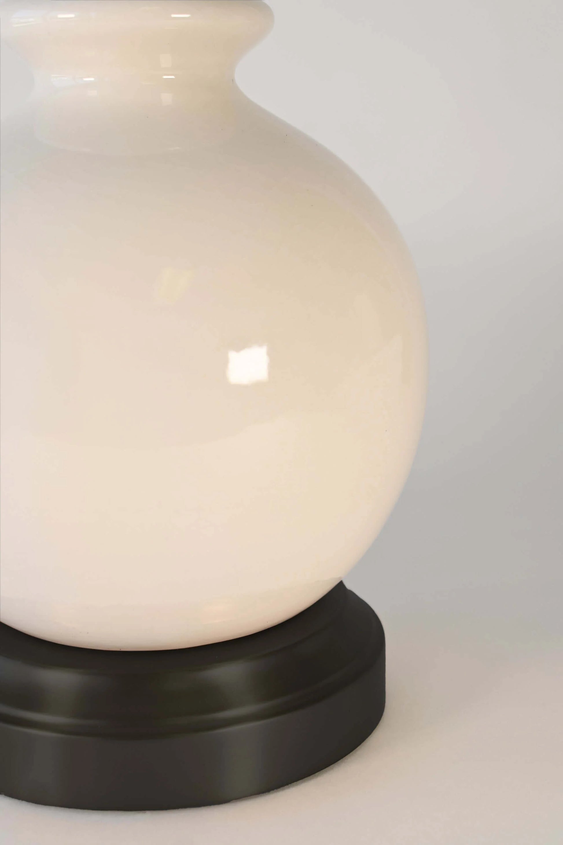 Ivory ceramic accent lamp with cordless functionality and warm ambient lighting