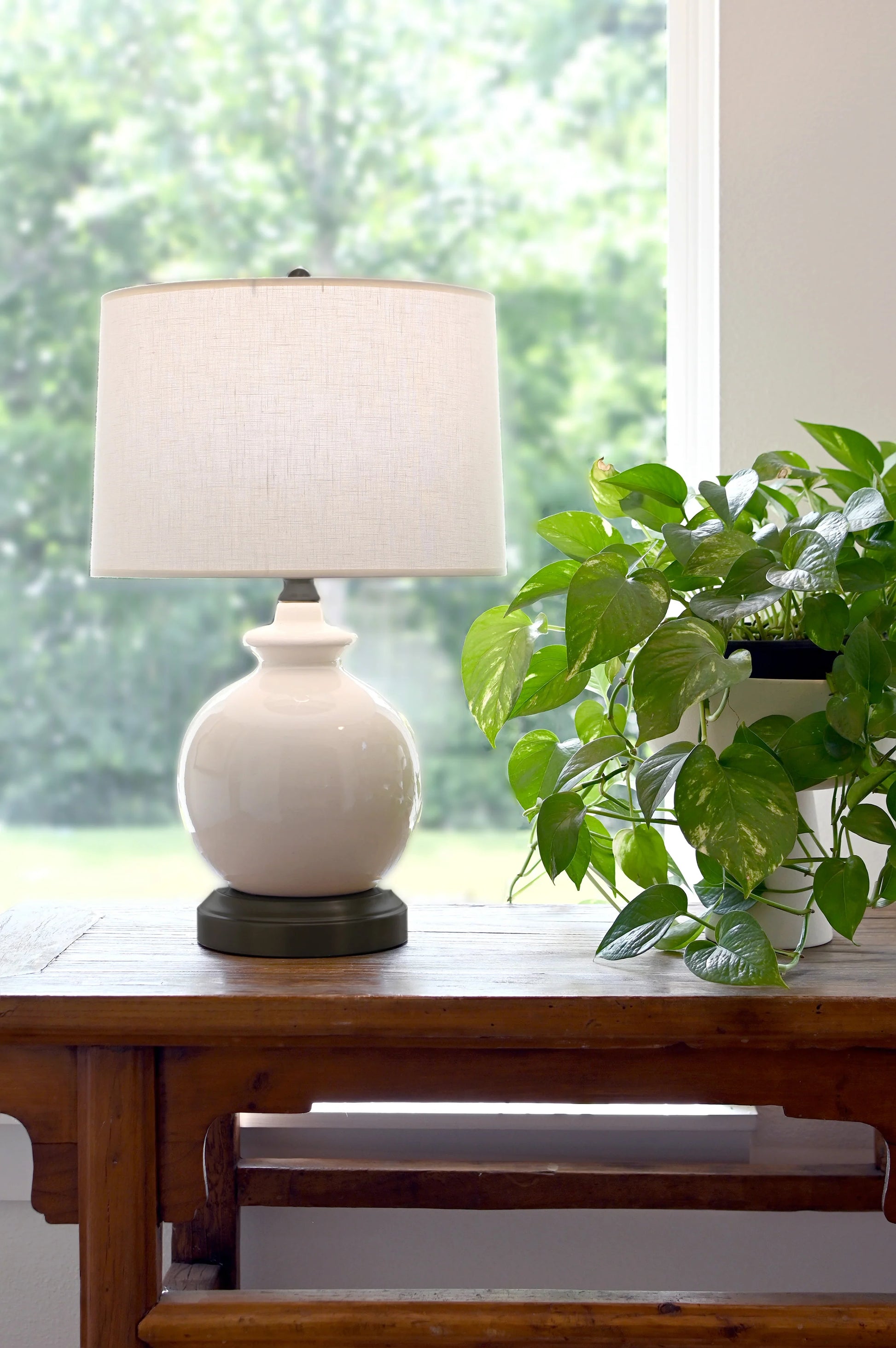 Elegant ivory ceramic cordless lamp with sculptural curved base design