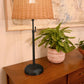 Rechargeable cordless Alexis Table Lamp with black base and rattan shade