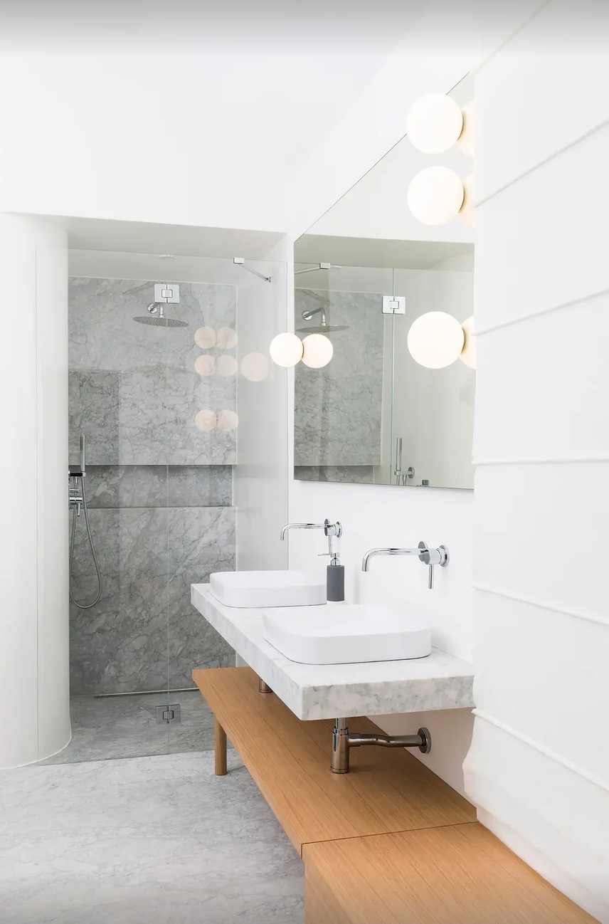 Artemide Dioscuri globe light mounted on bathroom wall