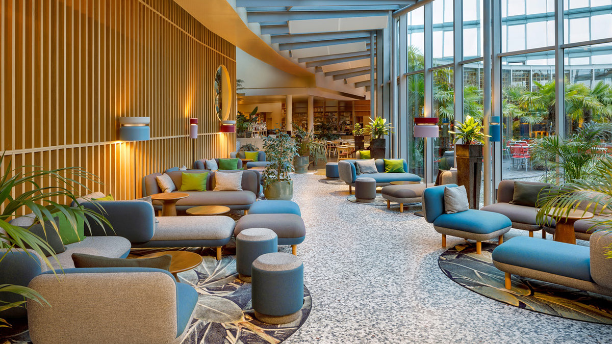 Lounge with plants and sofas from a B.lux Aspen installation