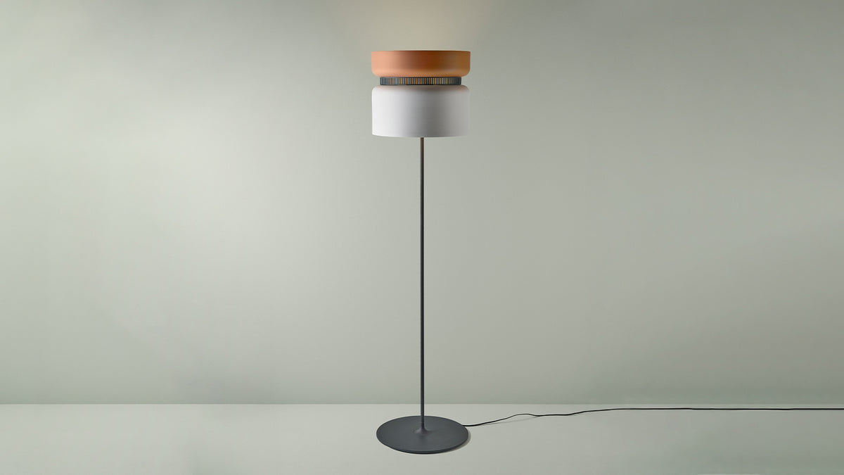 B.lux Aspen floor lamp with a terracotta-orange top shade and white bottom shade, studio view
