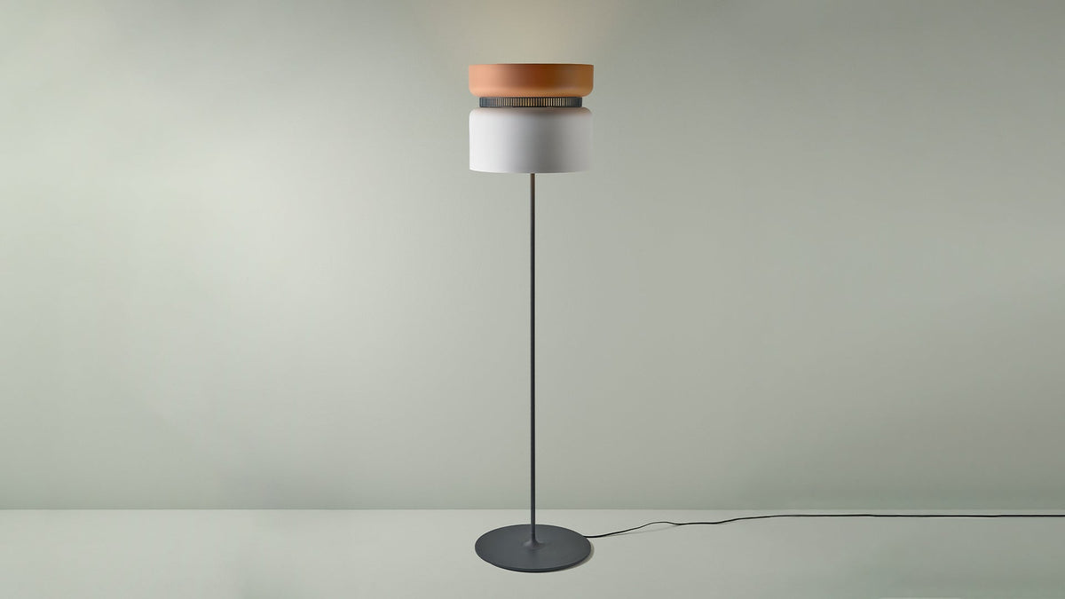 B.lux Aspen floor lamp with a terracotta-orange top shade and white bottom shade, studio view