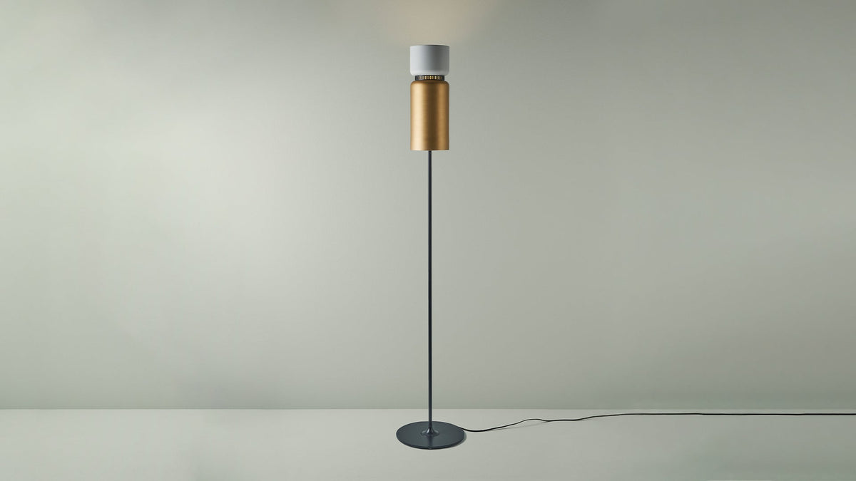 B.lux Aspen floor lamp with a white top shade and brass bottom shade, studio view