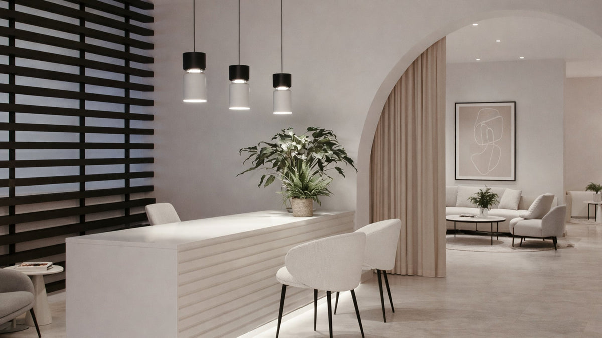 B.lux Aspen pendants over a reception desk in a lobby