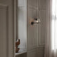 Astep 237/1 wall sconce shown for scale, highlighting its compact 14cm clear glass sphere design.