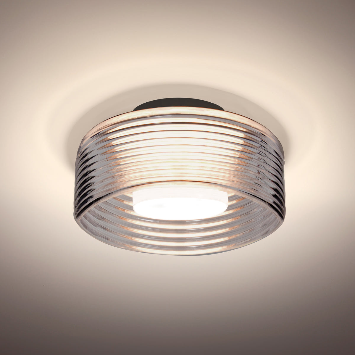 Besa Belu LED semi-flush ceiling light, Smoke ribbed drum glass, black canopy – studio view (Besa photographs Smoke in Black and Clear in Satin Nickel; Bronze uses the same glass)