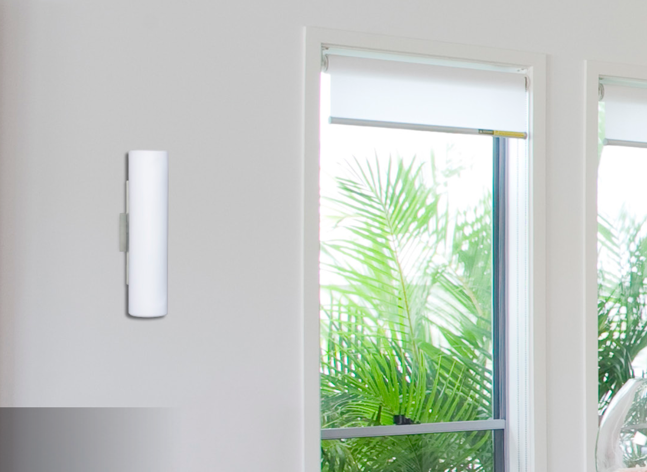Modern Besa Baaz wall sconce mounted vertically beside a living room