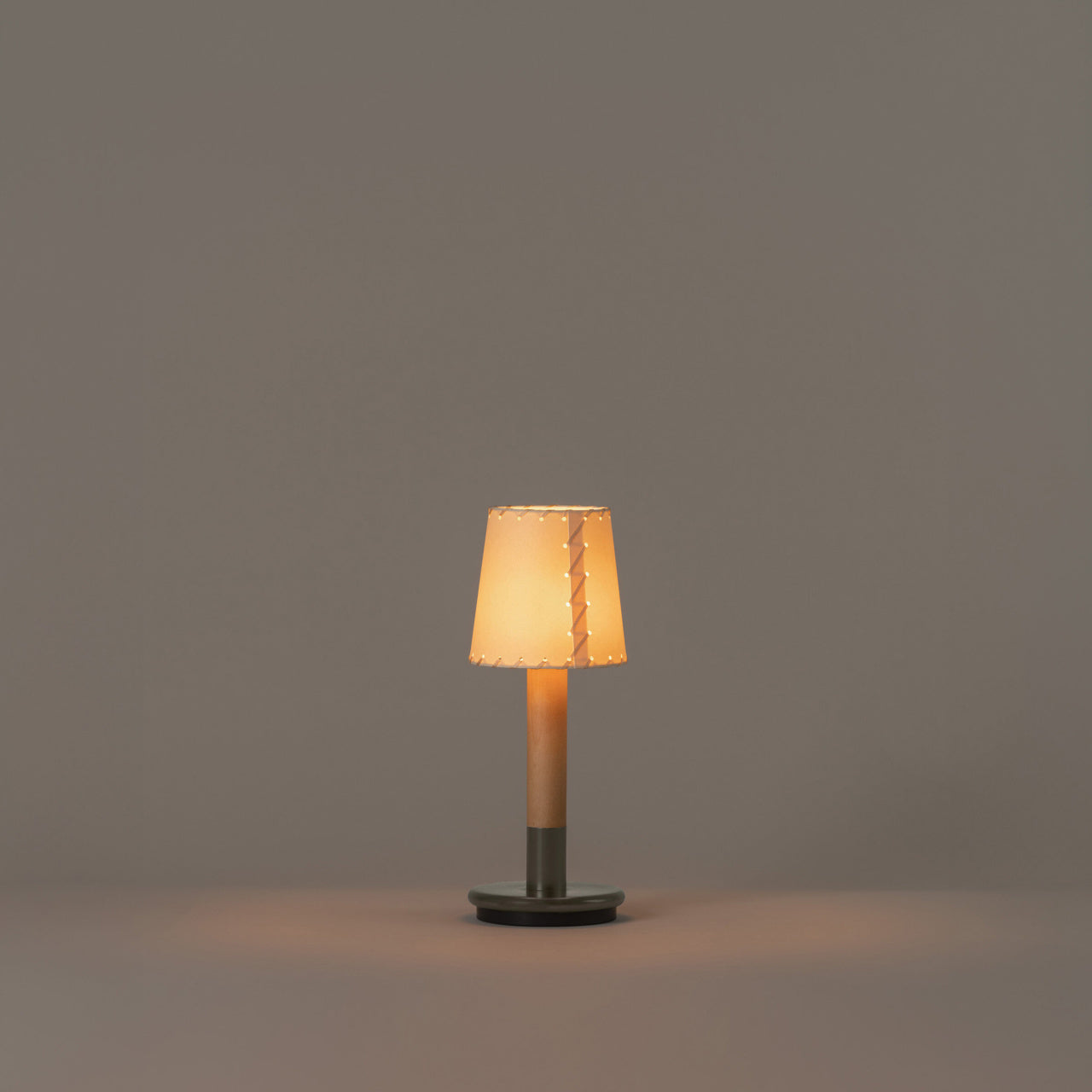 Rechargeable designer lamp for luxury living spaces with beige parchment shade
