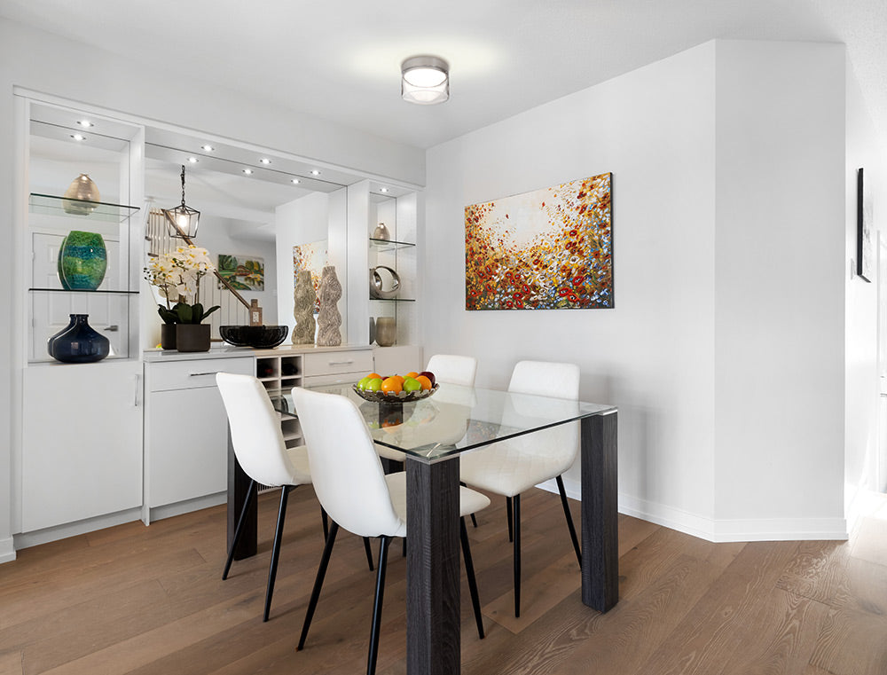 Besa Epic modern ceiling fixture with satin nickel finish and clear glass over dining talble