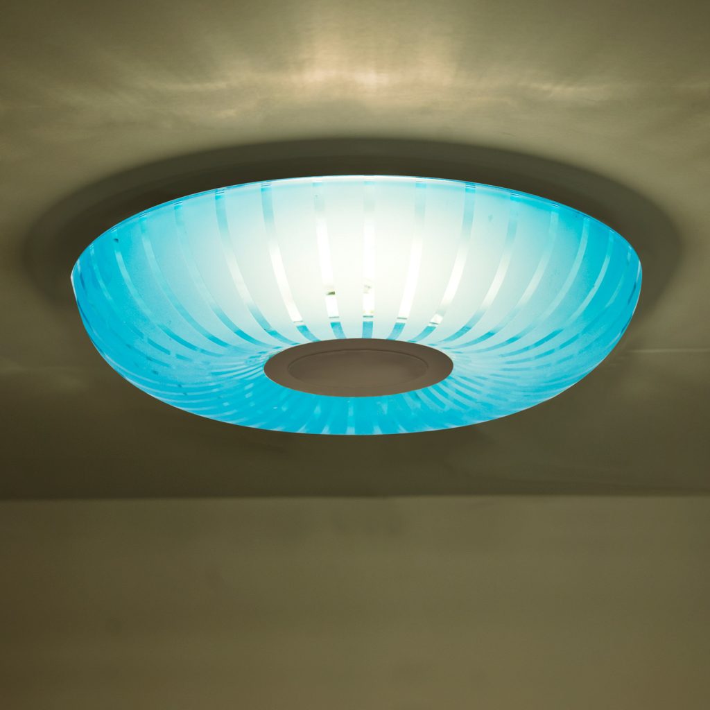 Handcrafted coral blue glass diffuser featuring frosted radial patterns for decorative LED lighting