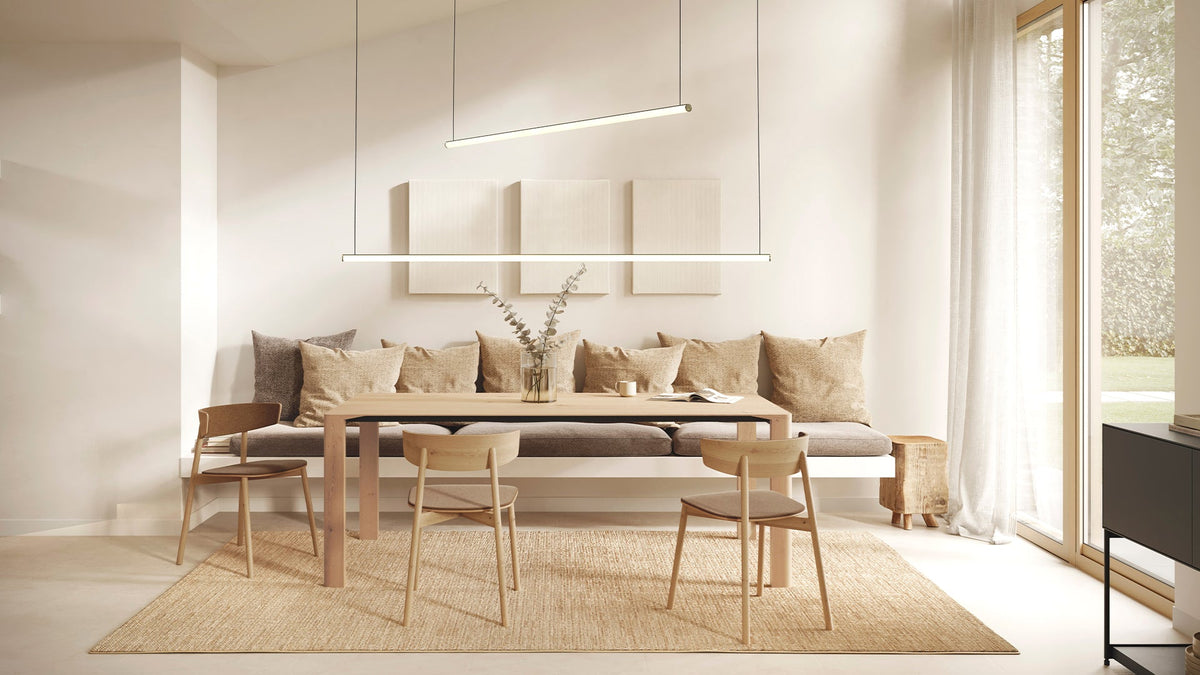 Blokinline LEDtube linear pendant lamp over a dining table