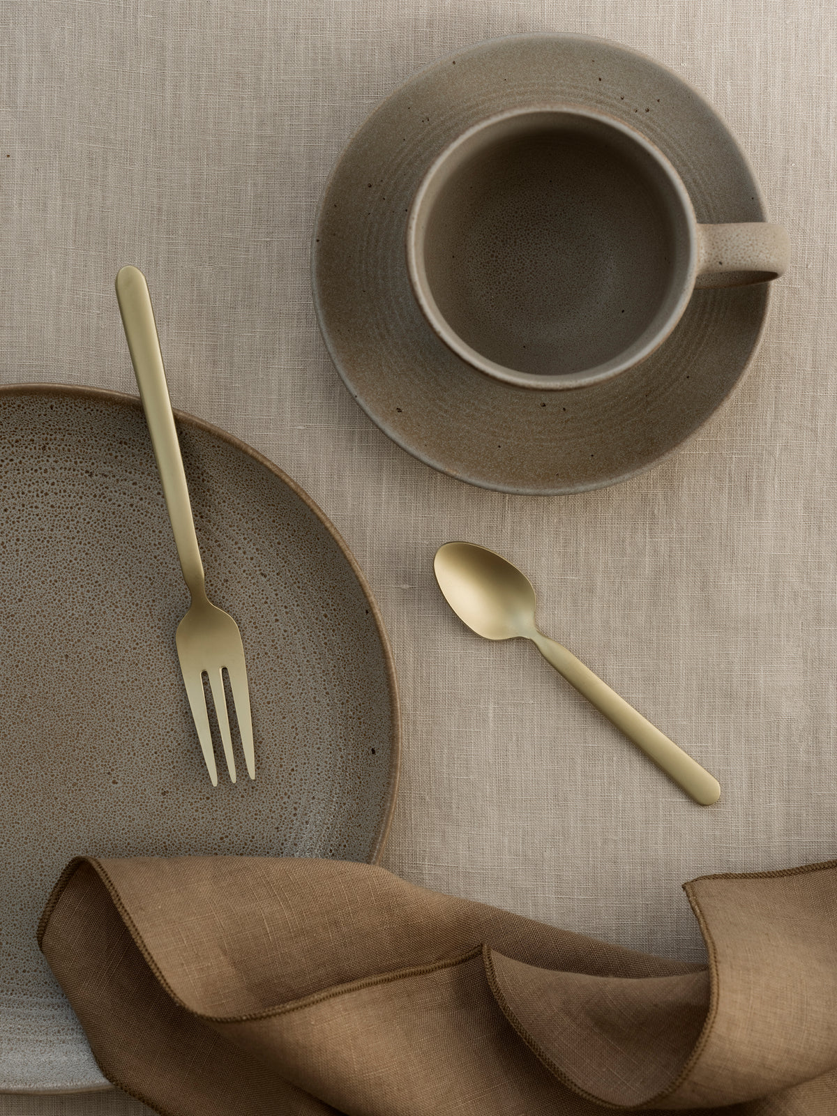 blomus KUMI Coffee Cups & Saucers 6.4 oz, Set of 2 – Fungi coffee cup and saucer with gold cutlery from above