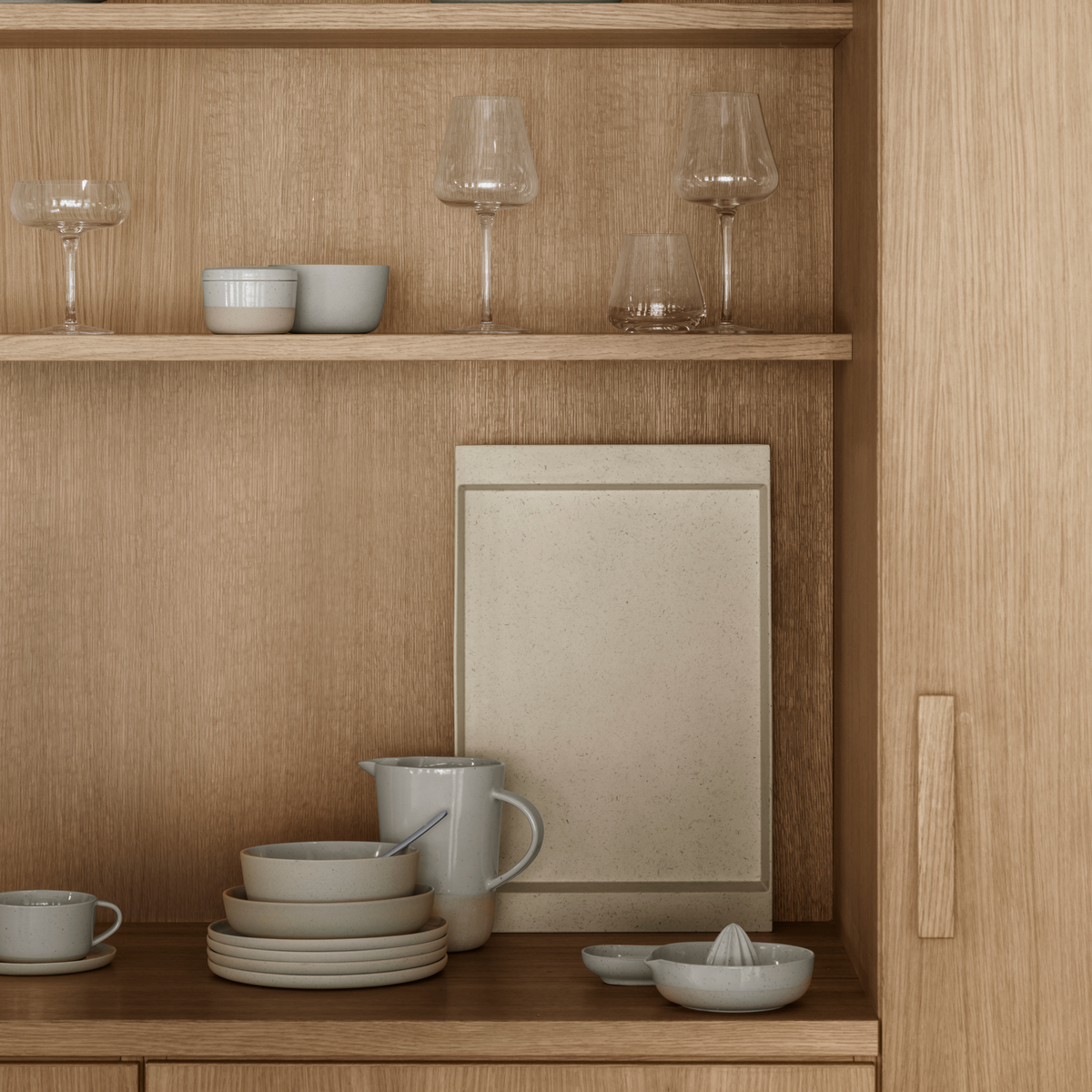 blomus SABLO Stoneware Citrus Juicer with Spout – SABLO pieces in an oak cabinet
