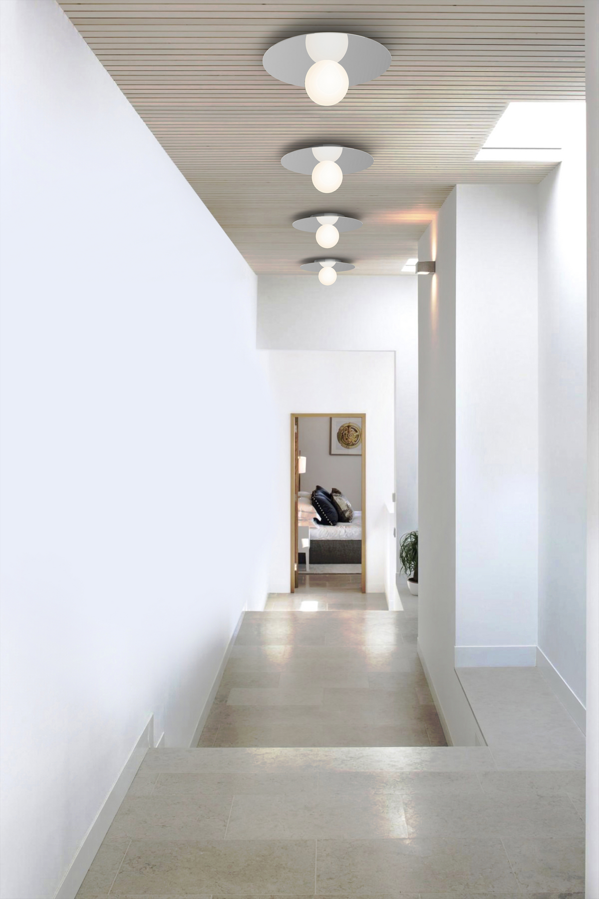 Bola Disc Colors flush mount lit in a tall interior