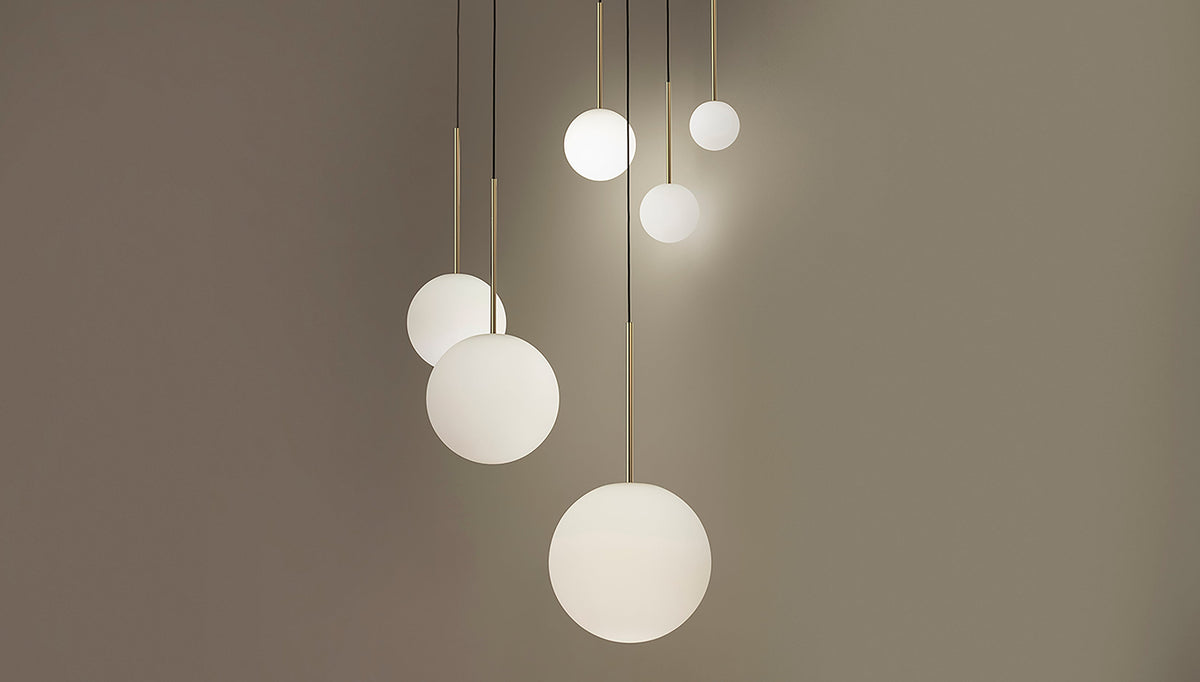 Cluster of Bola opal globes lit at varied heights in a staged shot