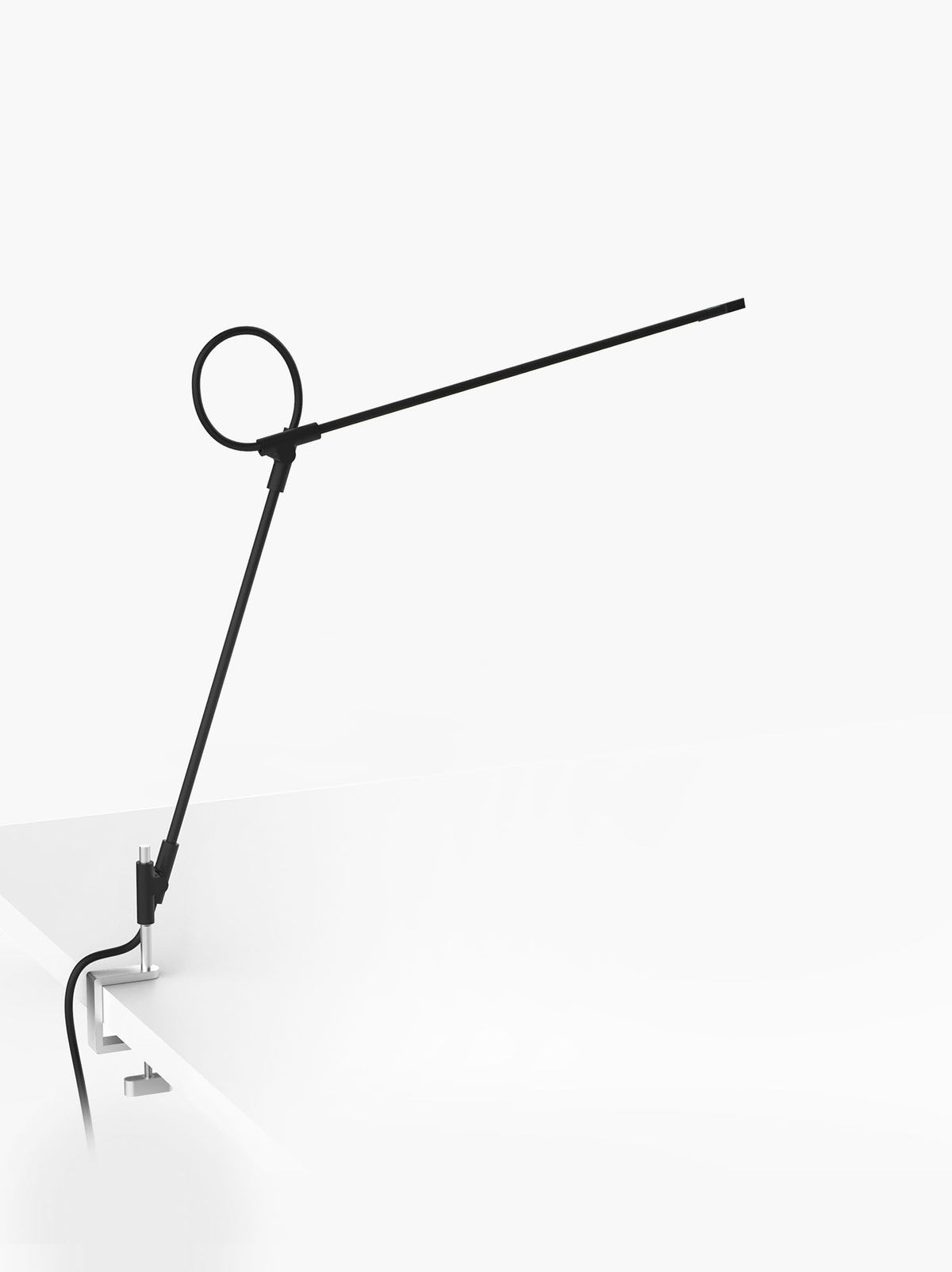 Superlight clamp lamp in black on a plain background