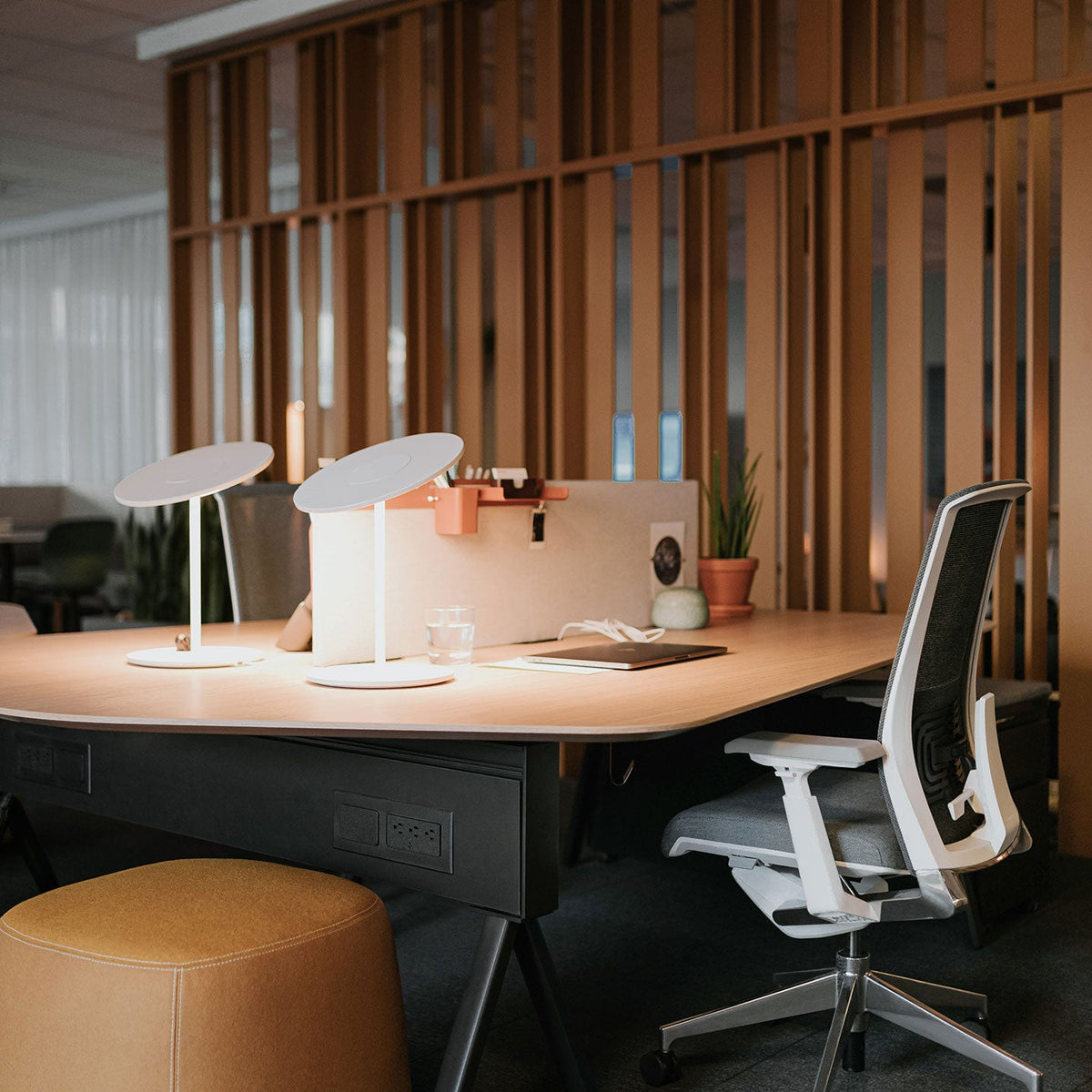 Circa disc lamp on a shared desk, environmental photo