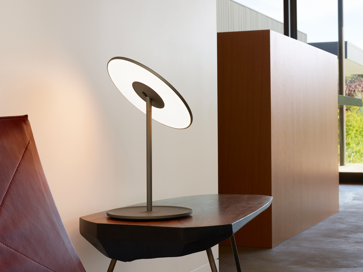 Circa lamp family on a desk in a modern workspace
