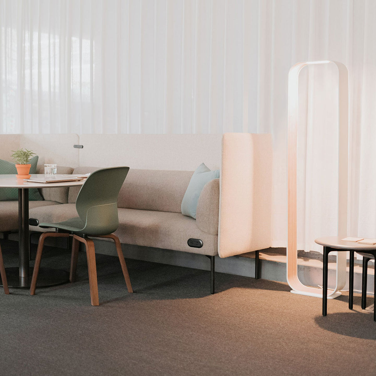 Contour floor lamp frame holding books and objects on its interior surface