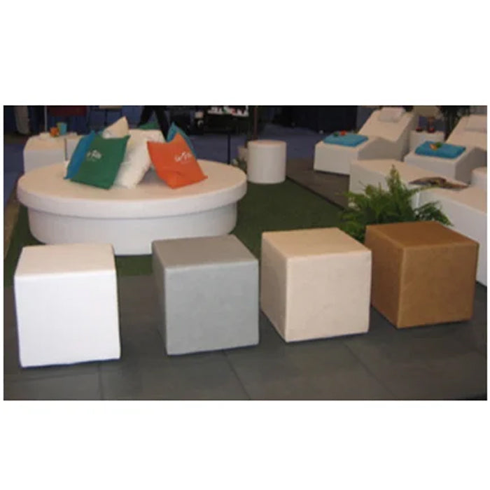 Three white Dot 2 cube ottomans in an art gallery in front of large paintings