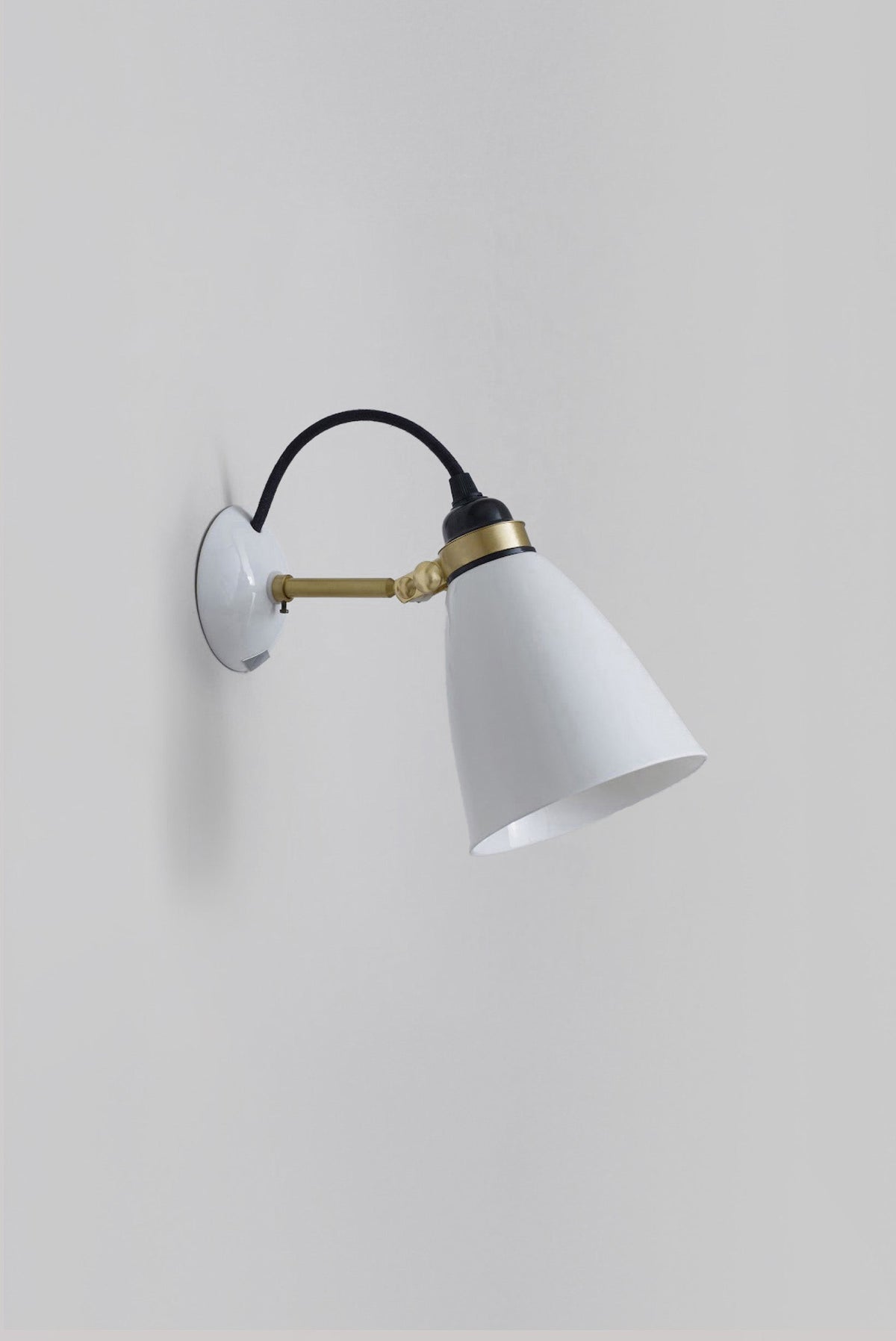 Hector 30 Medium Dome Wall Light in Satin Brass w Black Cable – maker studio view