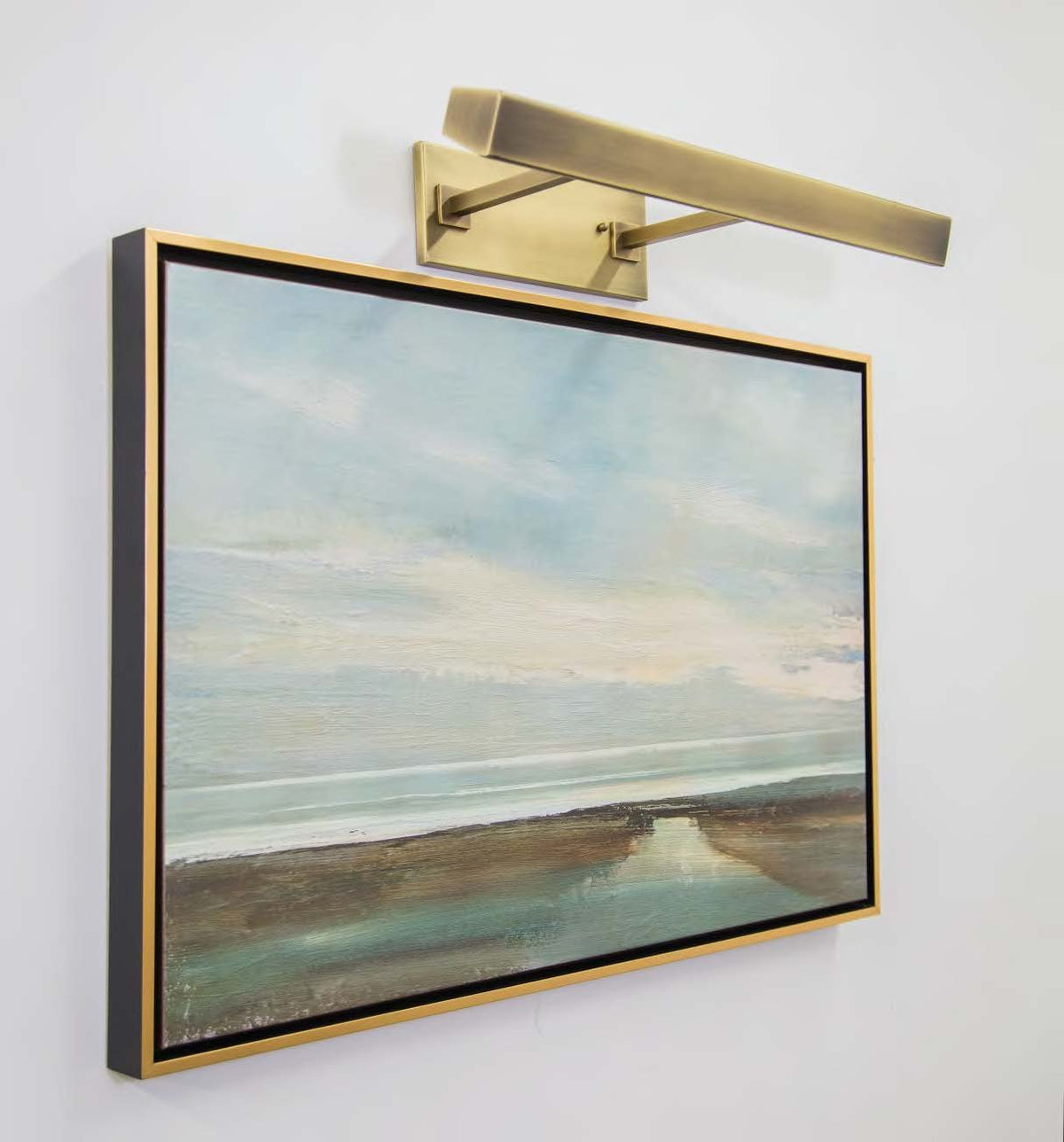 House of Troy Guilford 24" Direct Wire LED Picture Light in Antique Brass in a room setting