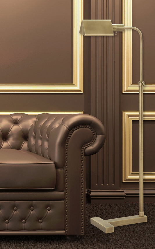 House of Troy Fairfax Adjustable Pharmacy Floor Lamp in Antique Brass in a room setting (view 2)