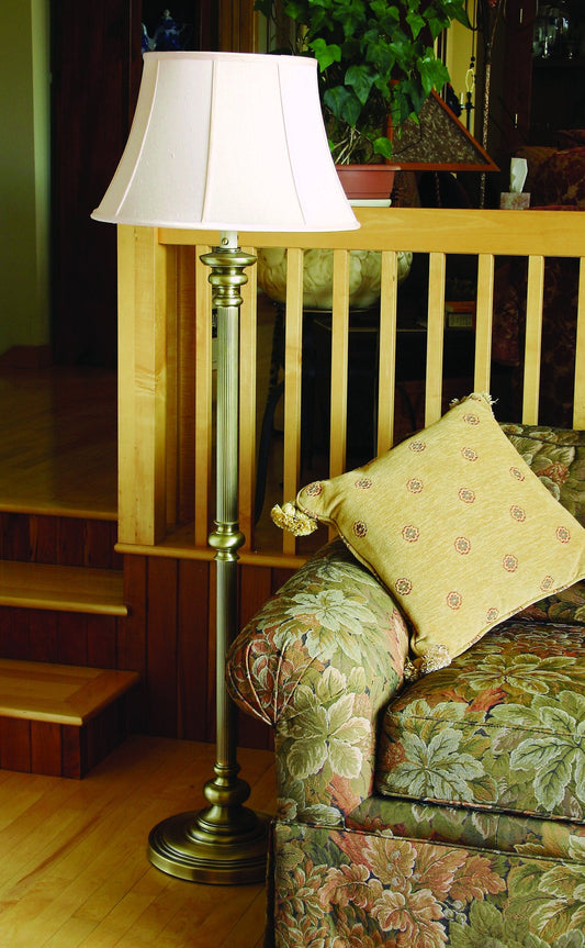 House of Troy Newport 57.5" Twin Pull Floor Lamp in Antique Brass in a room setting