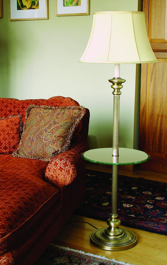 House of Troy Newport 55.75" Floor Lamp with Glass Table in Antique Brass in a room setting