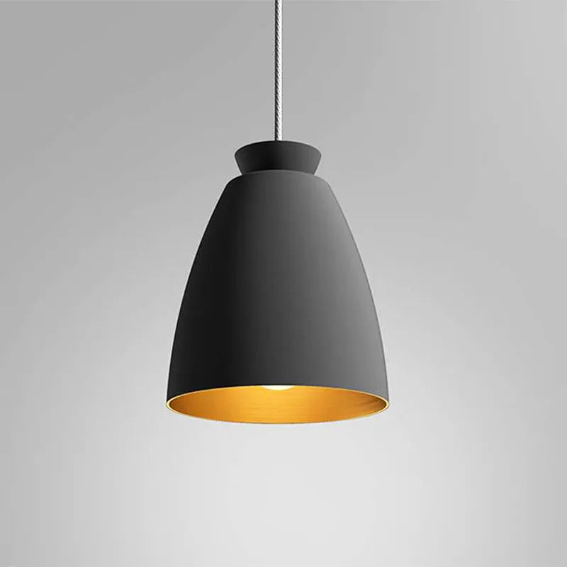 Black Chelsea Pendant Light by Innermost with matte black exterior and gold interior above kitchen island”