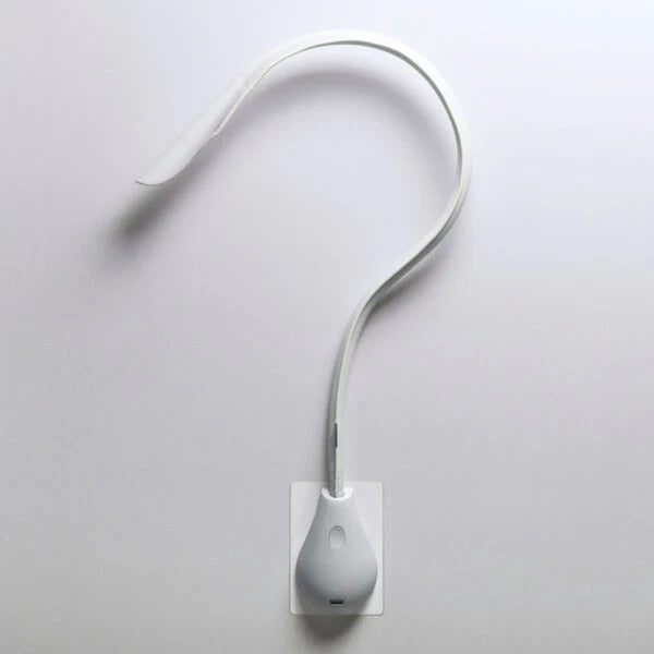 Modern Innermost Cobra wall sconce in pristine white leather, highlighting its minimalist design for contemporary spaces.