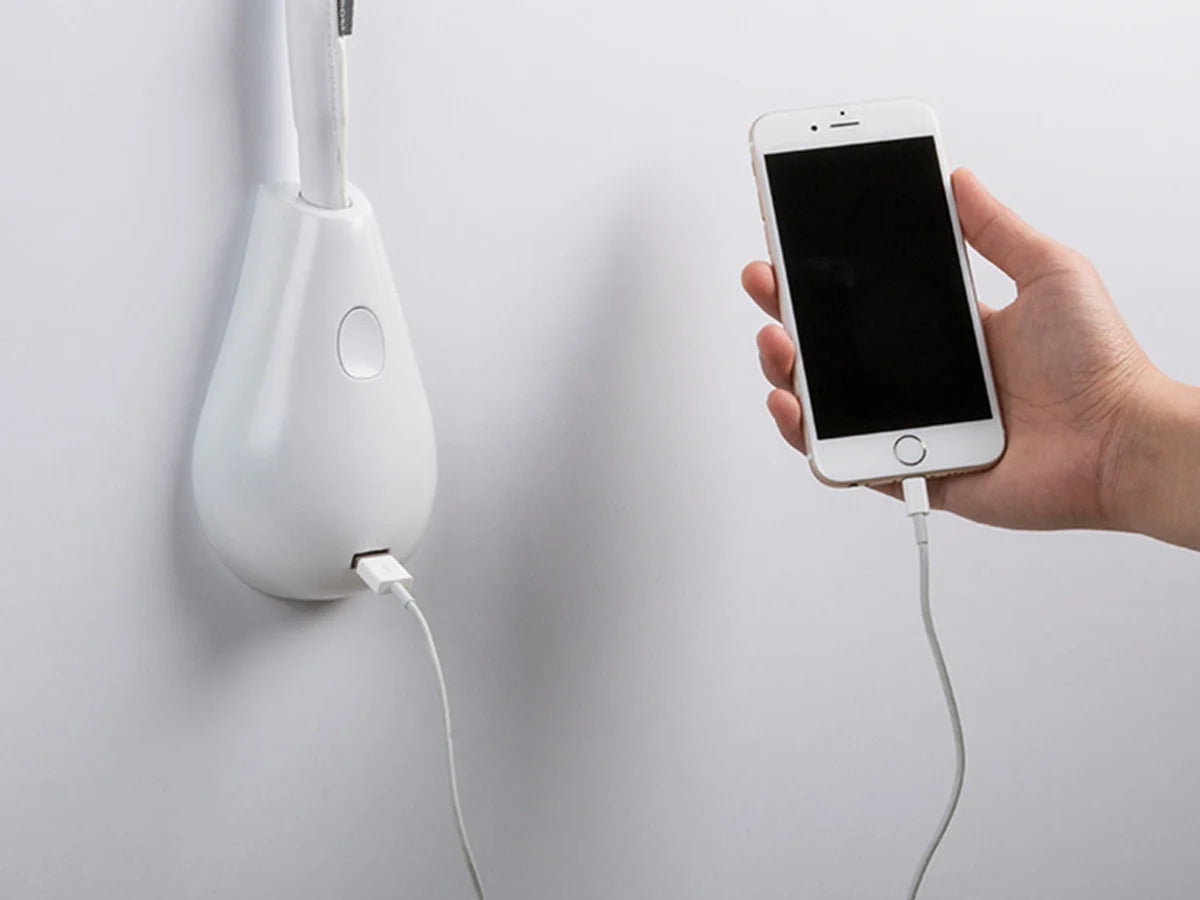 Elegant white leather Innermost Cobra lamp with dimmable LED and built-in USB charging for minimalist interiors.