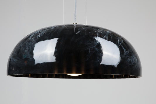 Innermost Doric 60 LED pendant light in polished black marble finish, hanging over a modern dining table.