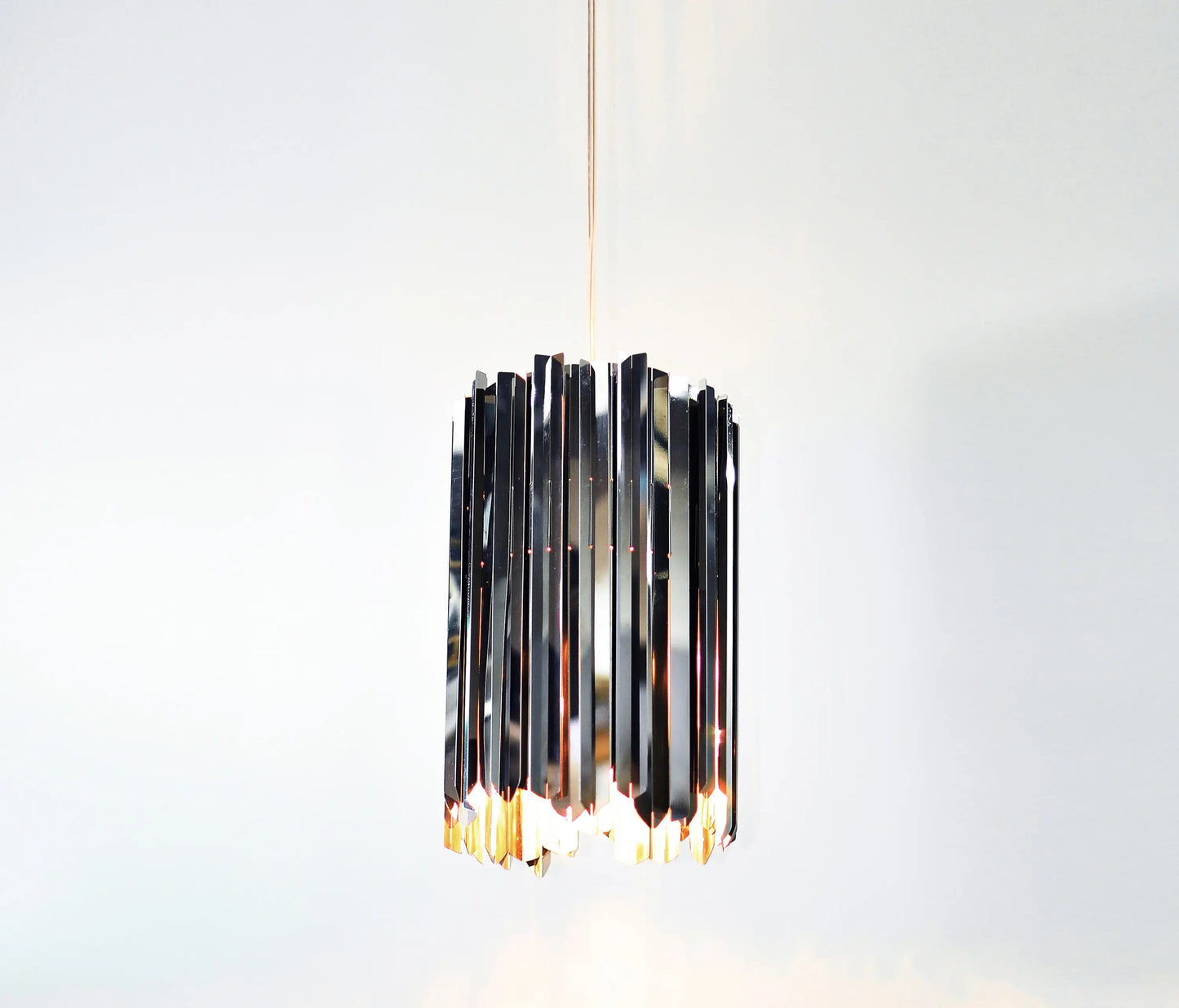 Small modern pendant light, Innermost Facet 18, with mirrored surface appearing like crystal, suitable for kitchen island lighting.
