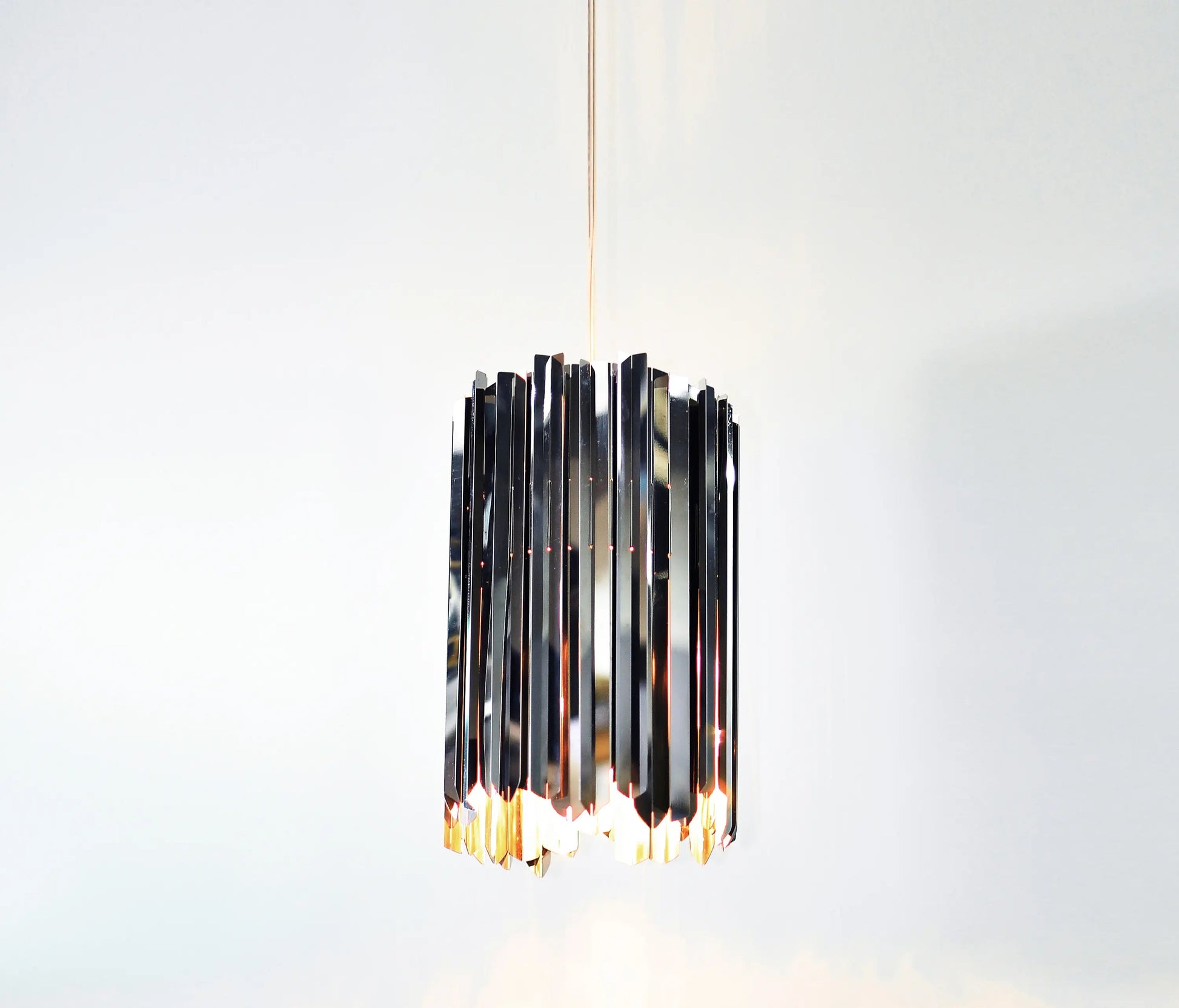 Small modern pendant light, Innermost Facet 18, with mirrored surface appearing like crystal, suitable for kitchen island lighting.