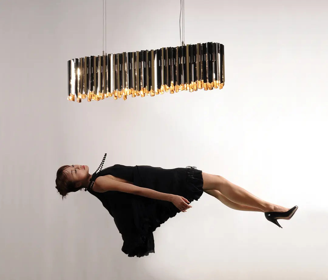 Modern linear suspension light by Tom Kirk with intricate etched facets. 