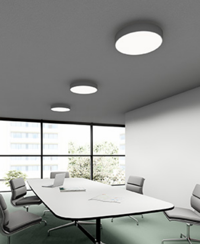 Dimmable flush mount ceiling light with integrated LED in matte white in conference room setting