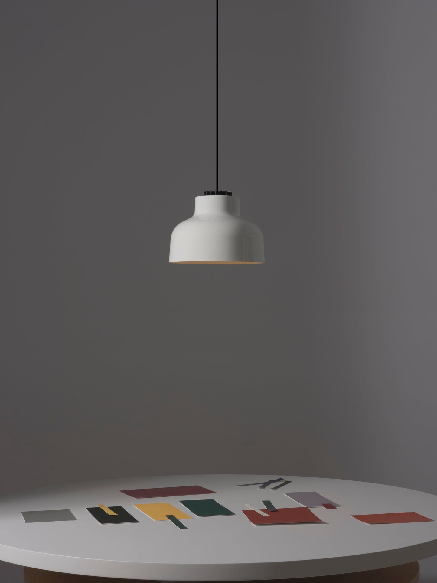 Mid-century modern pendant light above round dining table