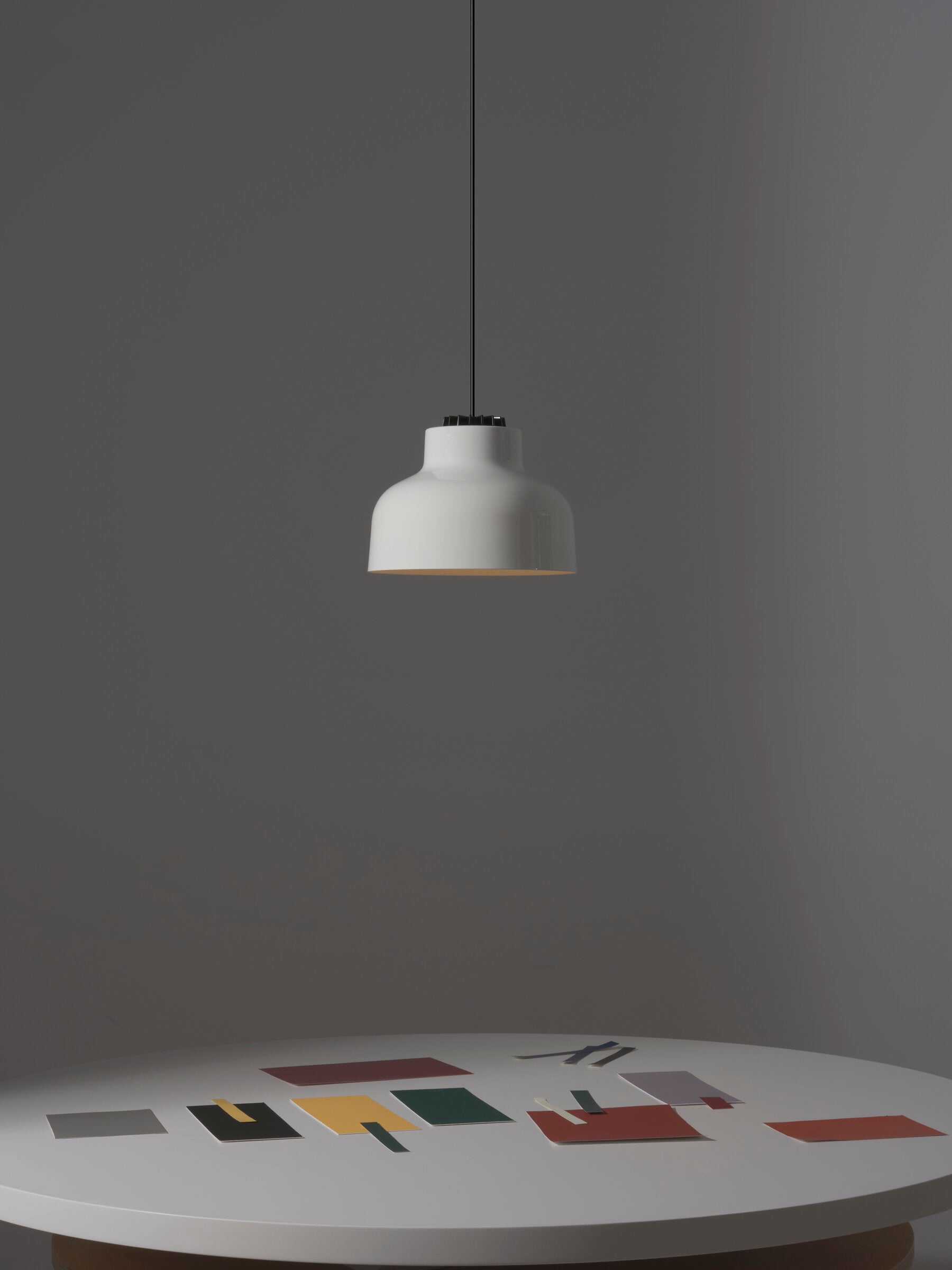 Mid-century modern pendant light above round dining table